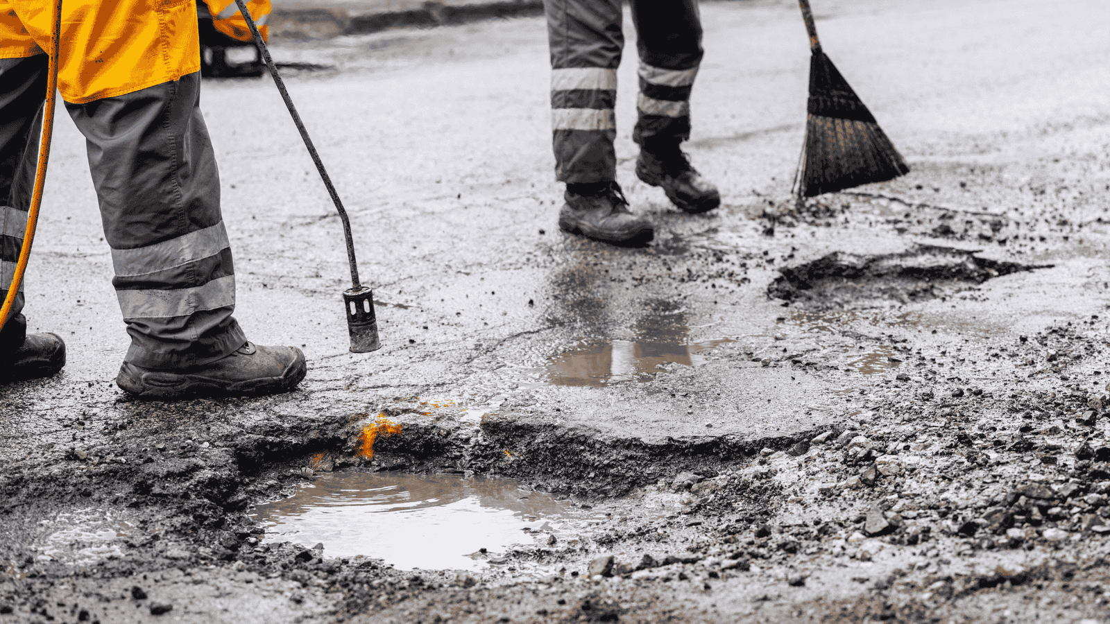 Road repair crew preparing potholes for asphalt patching to restore smooth and safe driving surfaces in Jacksonville, TX.